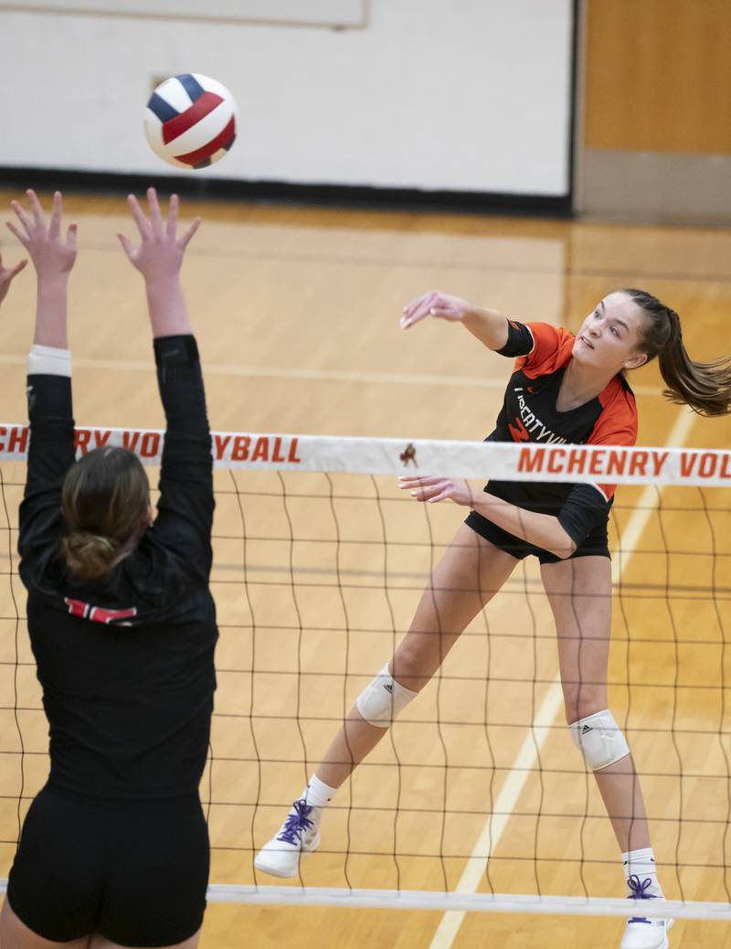 Libertyville's Claire Evans spikes the ball as Huntley's Georgia Watson attempts a block during the Class 4A Sectional girls volleyball final on Thursday, November 7, 2024 at McHenry High School. Ryan Rayburn for Shaw Local