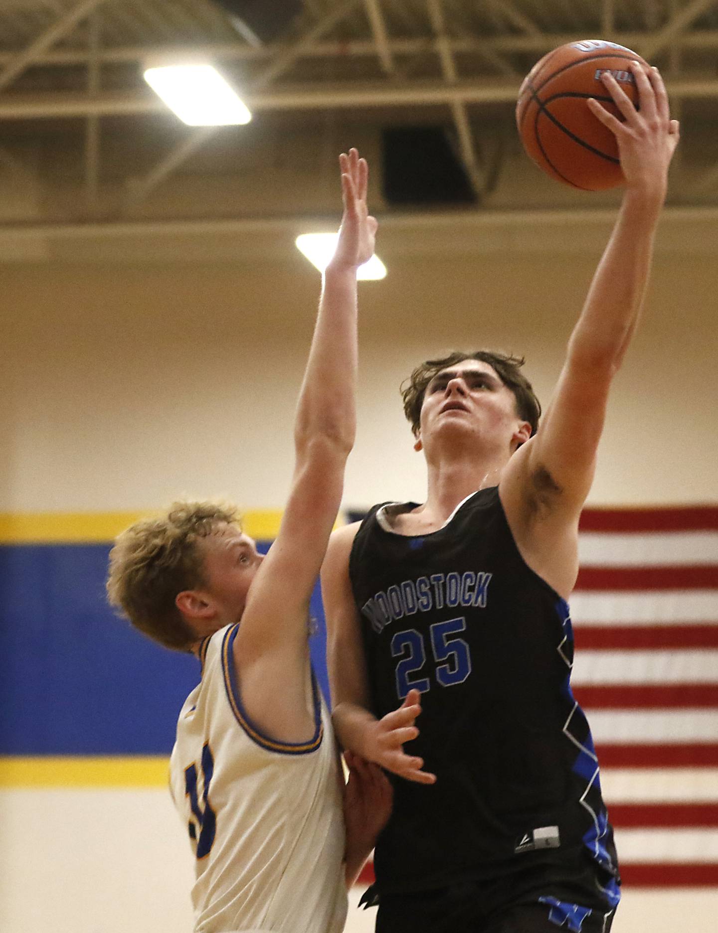 Woodstock'as Trent Butler drives to the basket against Johnsburg's JT Schmitt during a Kishwaukee River Conference boys basketball game Friday, Feb.9, 2024, at Johnsburg High School.