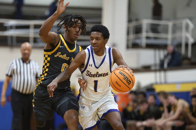 Joliet Central’s Bernal Fox works around Joliet West’s Aamir Shannon on Thursday, Jan. 15, 2026 in Joliet.