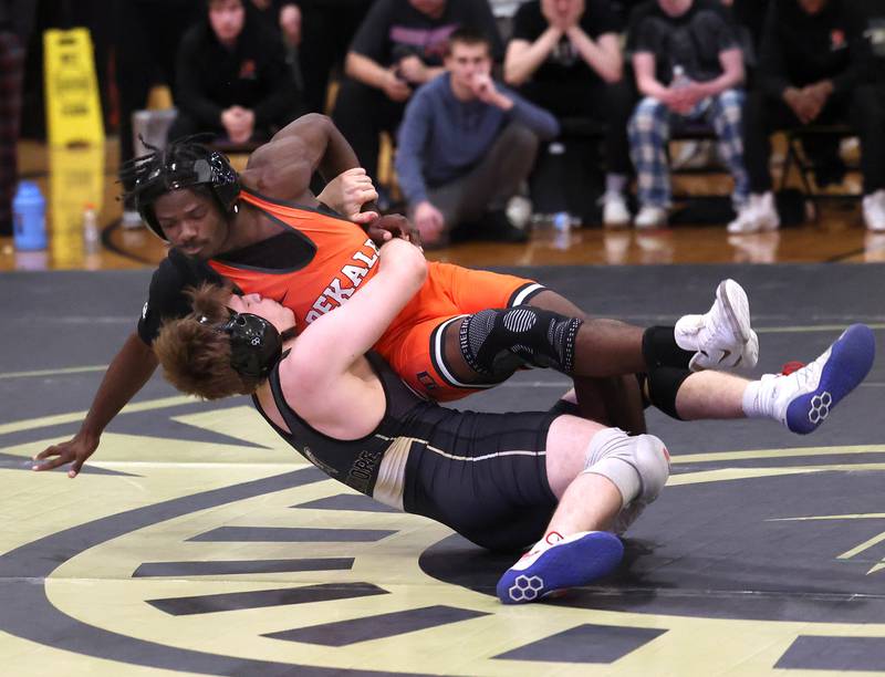 DeKalb’s Cam Matthews takes down Sycamore’s Douglas Gemberling during their match at 157 pounds Friday, Jan. 16, 2026, at Sycamore High School.