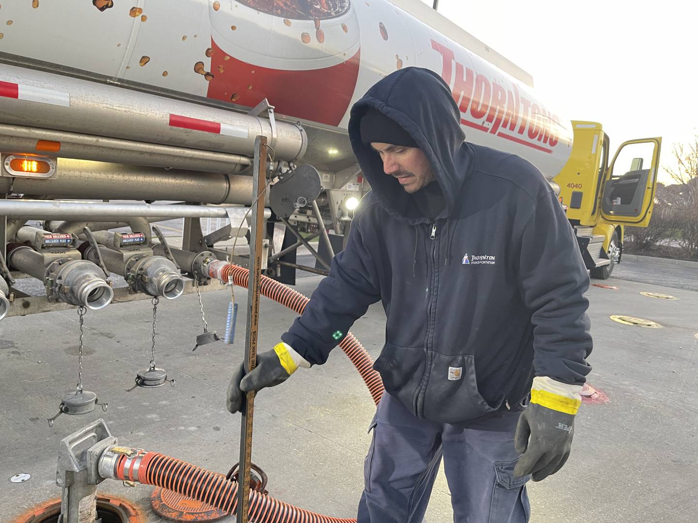 Sergio Munoz, a trucker for Thorntons, fills up a tank at a Thorntons gas station in Elgin on Thursday, April 6, 2023.