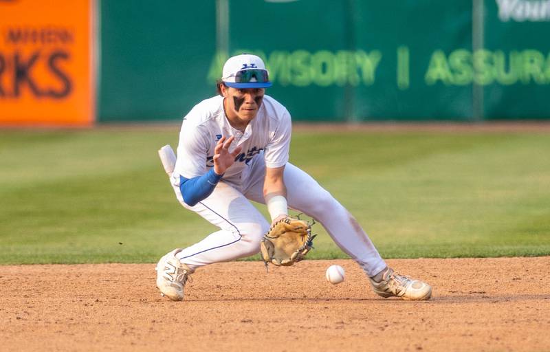 Newman Central Catholic shortstop Garret Matznick fields a ground ball during a game against Hope Academy at Northwestern Medicine Field in Geneva on Monday, June 2, 2025.