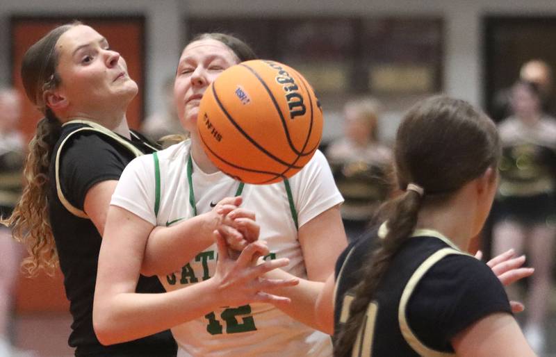 Crystal Lake South’s Gaby Dzik, center, loses a handle on the ball  as she collides with Sycamore’s Grace Amptmann, left, in girls IHSA Class 3A Sectional basketball on Tuesday, Feb. 24, 2026, at Crystal Lake Central High School in Crystal Lake.
