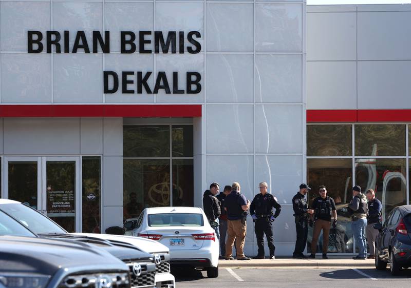 Law enforcement officers gather Wednesday, Oct. 23, 2024, outside of the Brian Bemis Toyota car dealership in DeKalb after responding to a stabbing where multiple employees were injured. The incident ended after police shot the man wielding the knife authorities said.