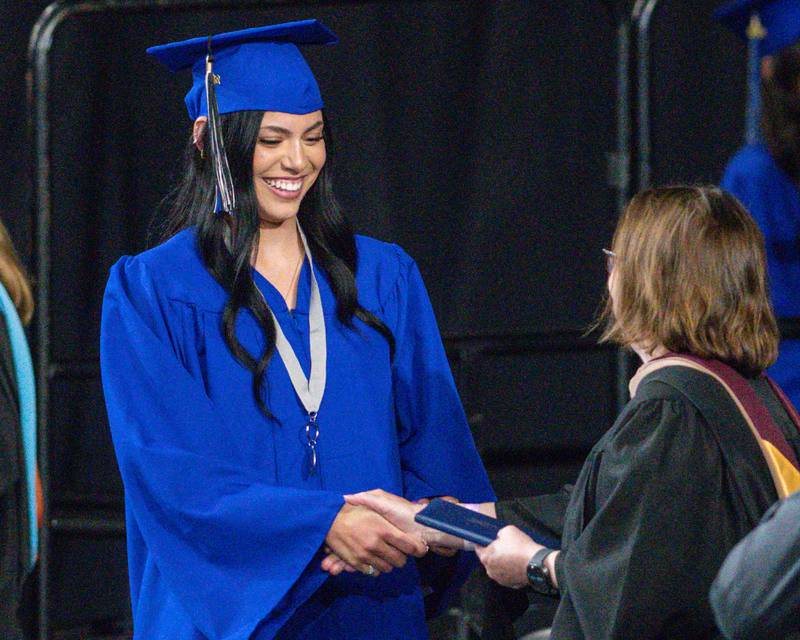 A St. Charles North graduate accepts her diploma on Monday, May 18, 2026, at the ceremony held at the Convocation Center in DeKalb.