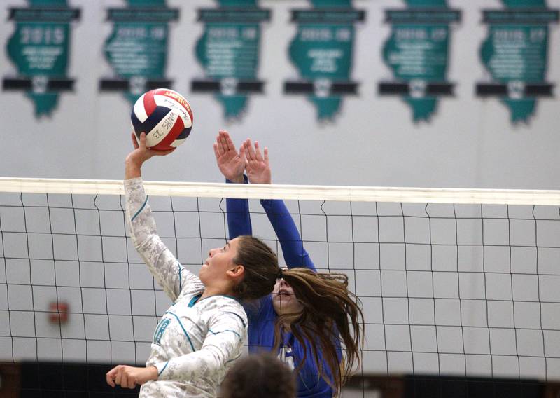 Woodstock North’s Gabriella Schefke, front, moves the ball against Woodstock in varsity volleyball at Woodstock North Monday night.