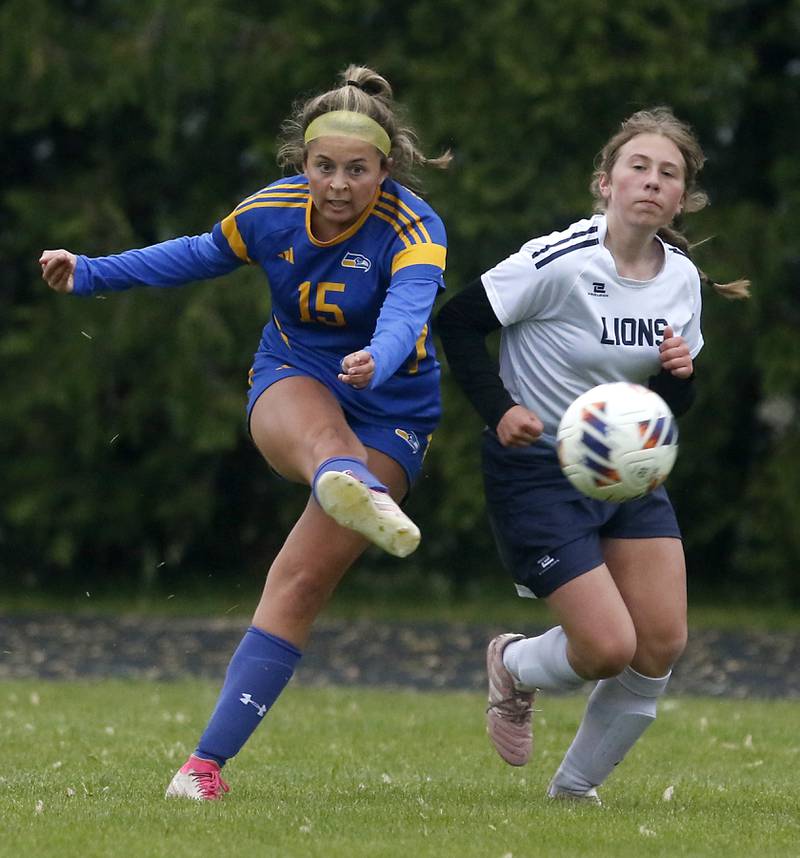 Johnsburg's Lauren McQuiston takes a shot on goal as she is defended by Harvest Christian Academy's Sophie Bucknam during the Class 1A Marian Central Girls Soccer Regional Championship match Harvest Christian Academy on Tuesday, May 20, 2025, at Marian Central High School in Woodstock.