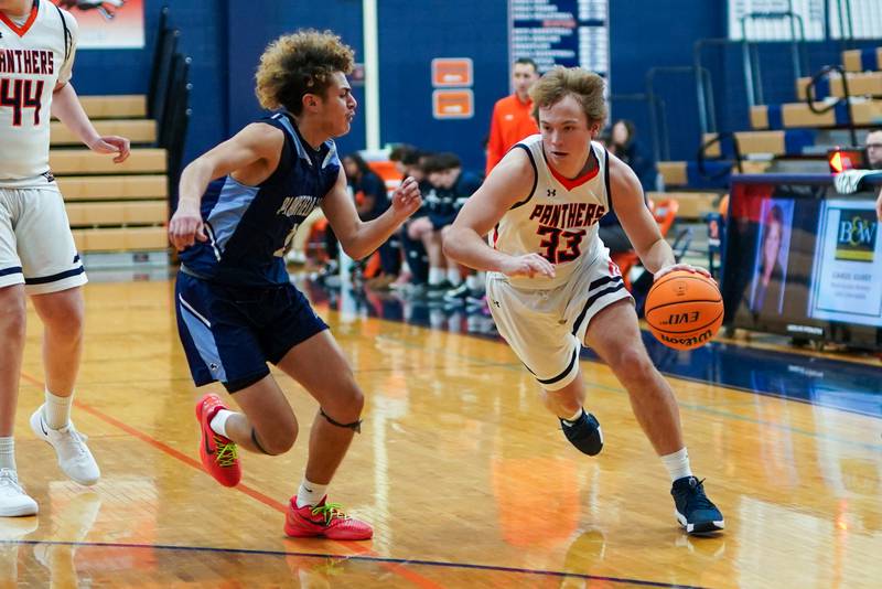 Oswego’s Graham Schwab (33) drives to the hoop against Plainfield South's Jeremiah Huerta (1) during a basketball game at Oswego High School on Friday, January 17, 2025.