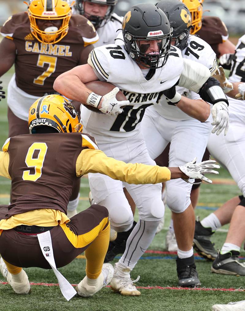 Sycamore's Zack Crawford looks to get by Carmel's Dev'ion Reynolds during their Class 5A second round playoff game Saturday, Nov. 5, 2022, at Carmel Catholic High School in Mundelein.