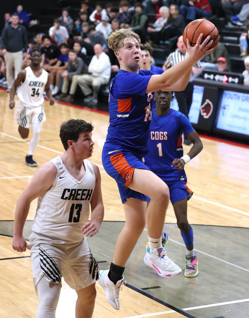 Genoa-Kingston's Hayden Hodgson shoots a layup in front of Indian Creek's Sam Genslinger Wednesday, Jan. 25, 2023, during their game at Indian Creek High School in Shabbona.