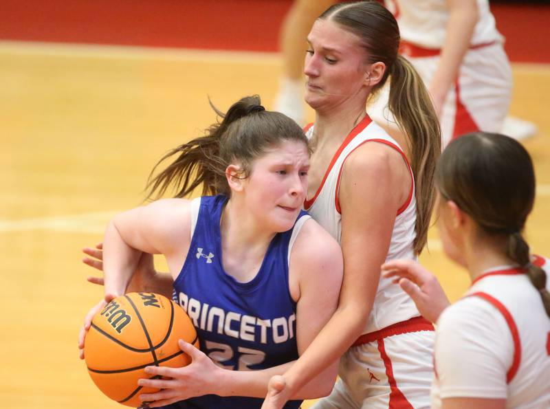 Princeton's Camryn Driscoll is stuck in the lane as Ottawa's Hailey Larsen defends on Monday, Feb. 3, 2025 in Kingman Gymnasium at Ottawa High School.