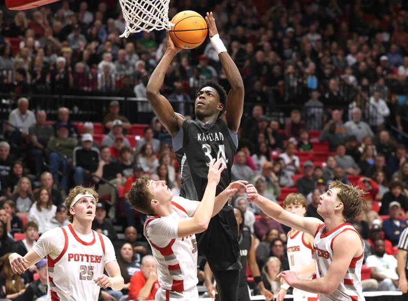 Kaneland's Jeffrey Hassan gets up a shot surrounded by three Morton defenders Monday, March 9, 2026, during their IHSA Class 3A supersectional matchup in the Convocation Center at Northern Illinois University in DeKalb.