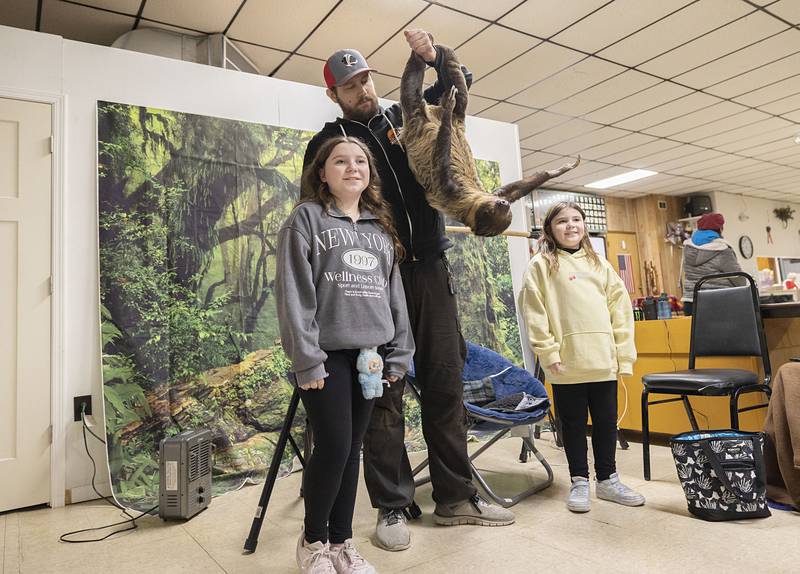 Harlo (left), 11, and Cicily Slater, 8, have their picture taken with Rico the Sloth and Dan Peterson, the not sloth, Saturday, Feb. 7, 2026, at Rock Falls’ Flock to the Rock.
