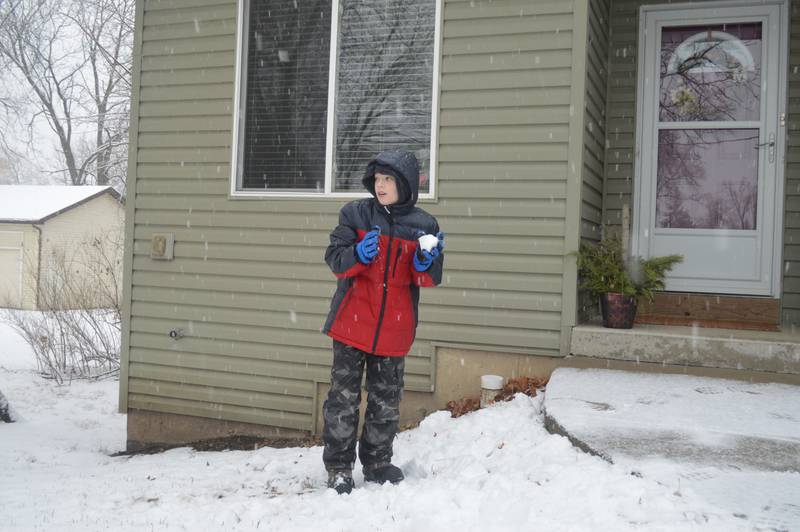 Luke McDonnell, 11, of McCullom Lake, gets ready to throw a snowball on Tuesday, Dec. 28, 2021, the new National Weather Service record for the latest measurable snowfall in Northern Illinois.