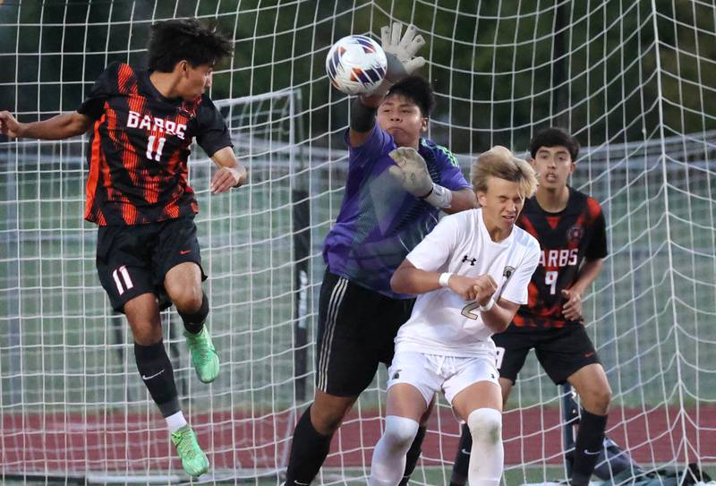 DeKalb goalie Diego Reyos knocks the ball away from Sycamore's Gavin Crouch on a corner kick during their game Thursday, Oct. 10, 2024, at DeKalb High School.