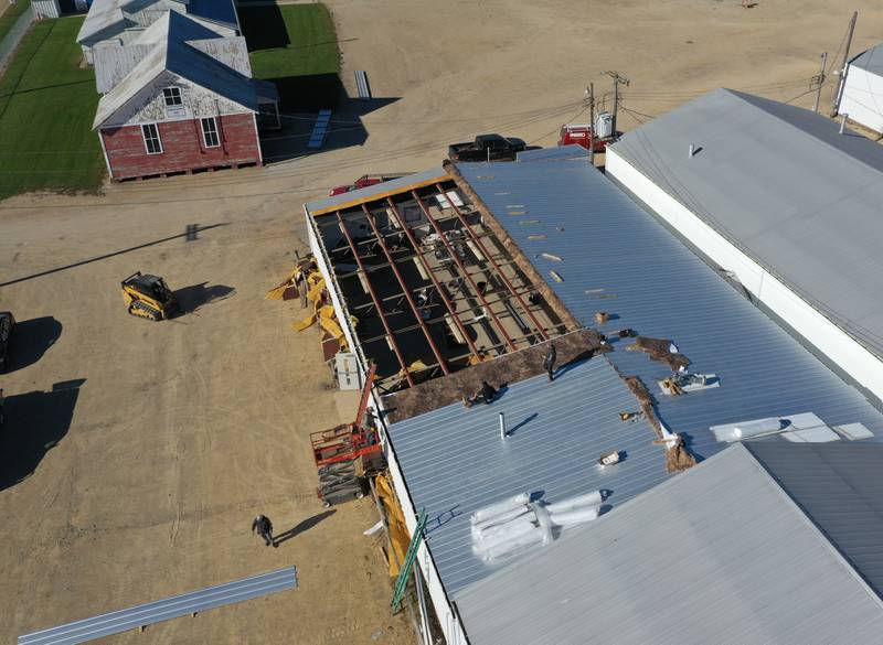 Crews from Vitale Construction work on replacing the roof of the exterior of the Exhibit Hall's 1 and 2 building on Wednesday, Nov. 8, 2023 at the Bureau County Fairgrounds in Princeton.