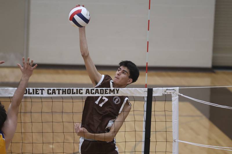 Joliet Catholic’s Aydan Garcia stretches for a shot against Joliet Central on Wednesday, April 1, 2026 in Joliet.