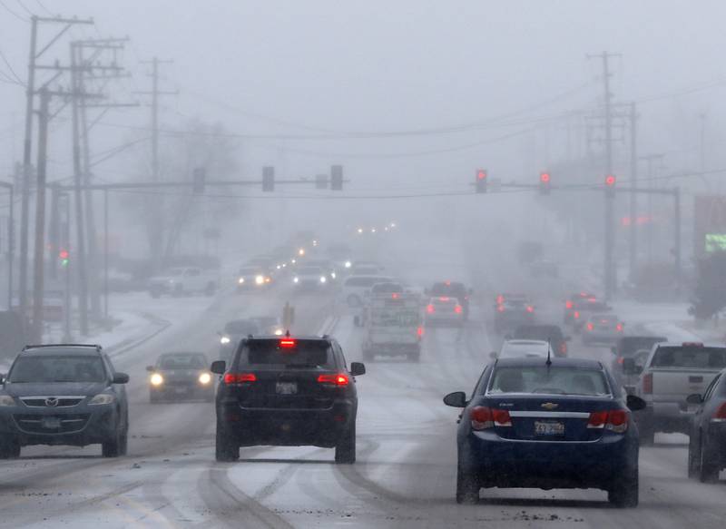 Traffic navigates Route 31 in McHenry as snow falls Thursday, Dec. 22, 2022, as part of a winter storm that hit northern Illinois.