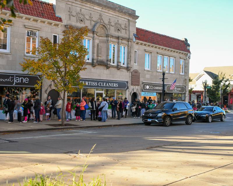 A line forms to get paint supplies during the Halloween window painting event held on Saturday Oct. 26, 2025, in downtown Downers Grove.