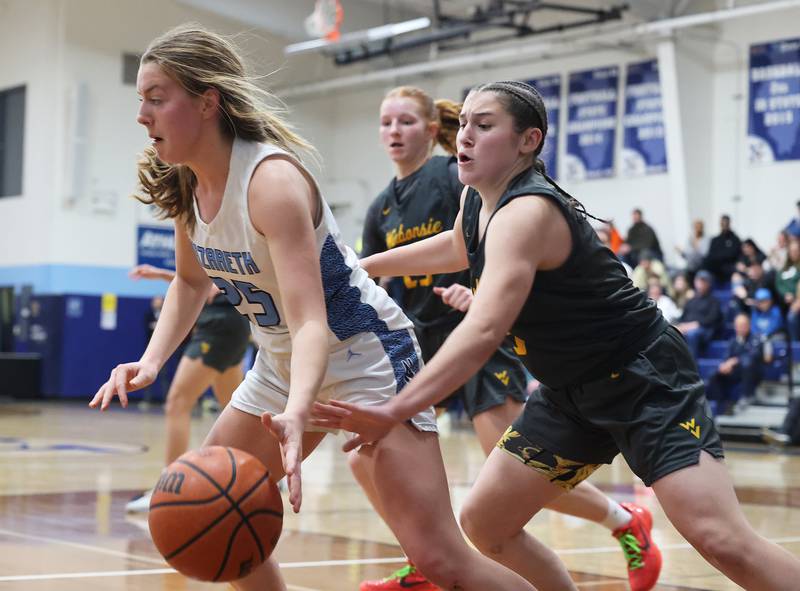 Nazareth’s Amalia Dray (25) drives past Waubonsie Valley’s Maya Cobb (3) during a girls varsity basketball game on Thrusday, Feb. 8, 2024 in La Grange Park, IL.