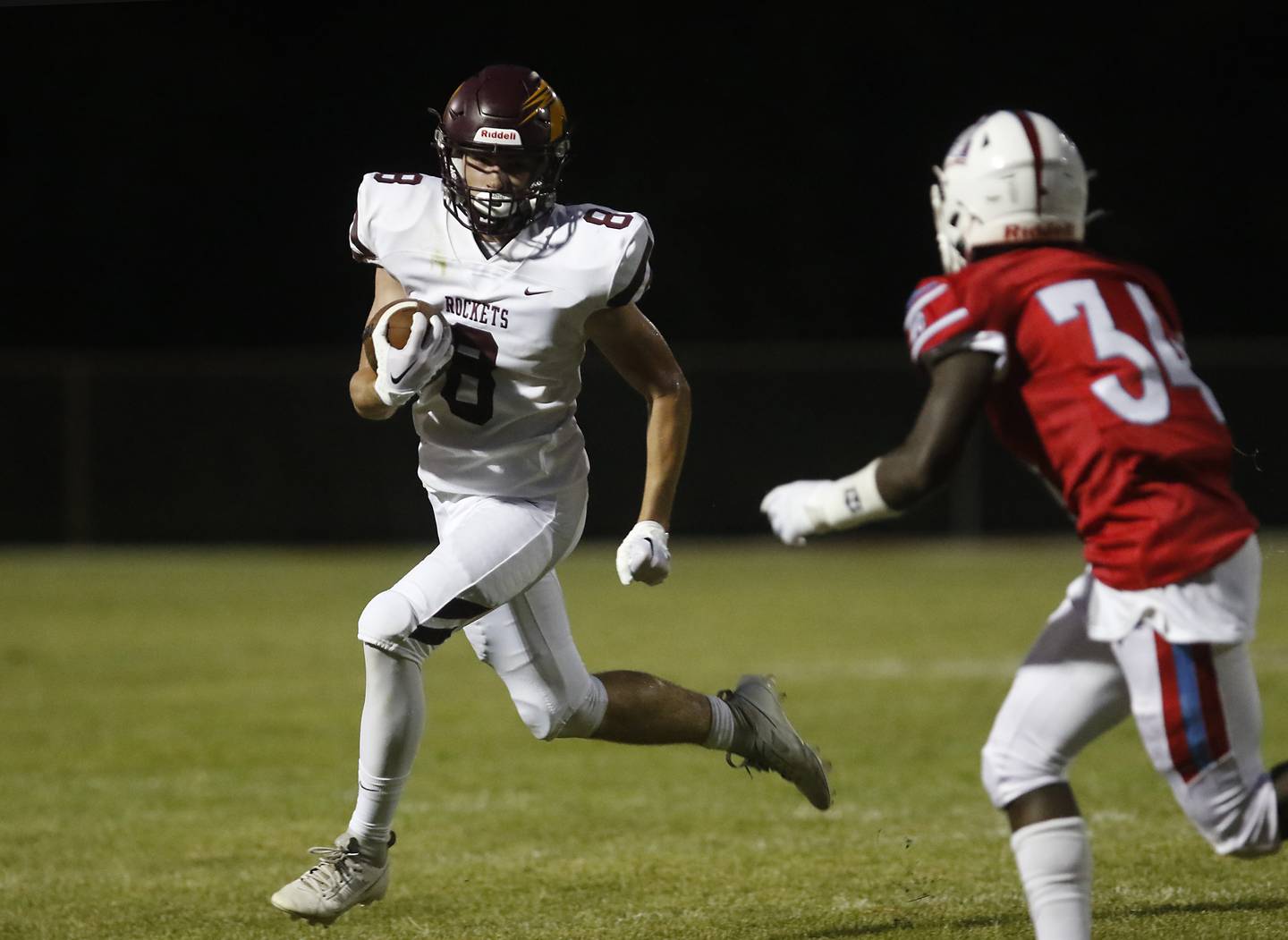 Richmond-Burton's Jack Martens runs with the ball as Marian Central's Steven Sarfo tries to chase him down during a nonconference football game Friday, Aug. 25, 2023, at Marian Central Catholic High School.