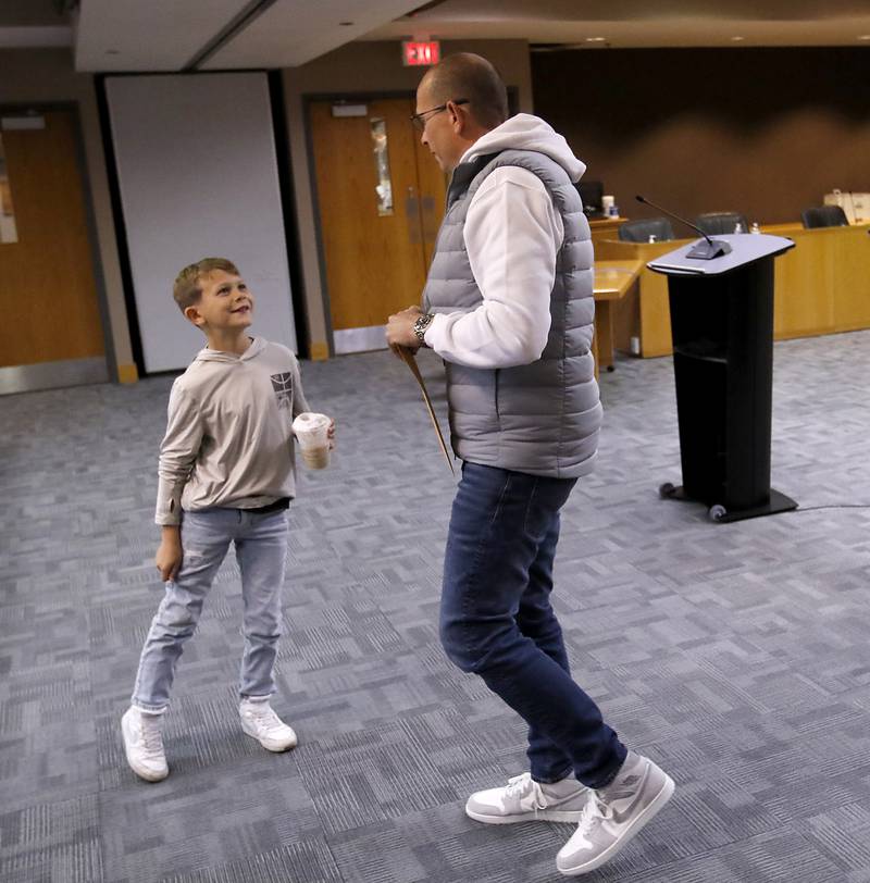 Greyson Jett, 8, greets his father, McHenry Mayor Wayne Jett, after Jett filed his paperwork Tuesday, Nov. 12, 2024, to run for another term as mayor of McHenry. Tuesday was the first day of filing for the consolidated election on April 1, 2025.