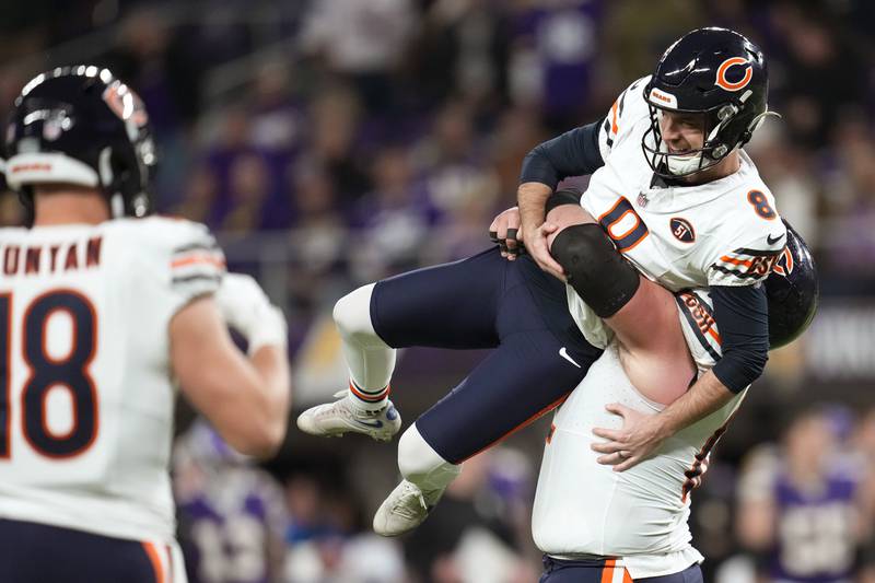Chicago Bears kicker Cairo Santos celebrates with teammate Lucas Patrick after kicking a 30-yard field goal during the final minute against the Minnesota Vikings, Monday, Nov. 27, 2023, in Minneapolis. The Bears won 12-10.
