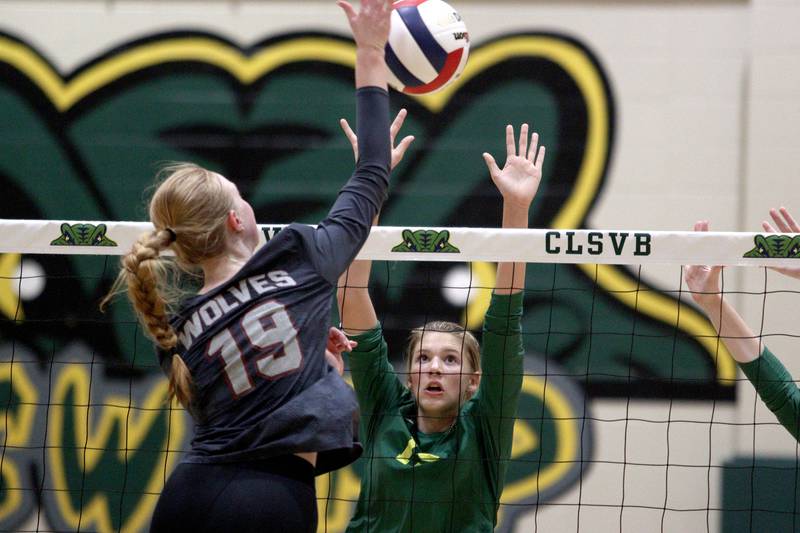 Crystal Lake South’s Logan Georgy, right, blocks as Prairie Ridge’s Ashley Stiefer hits the ball in varsity volleyball at Crystal Lake South Tuesday night.