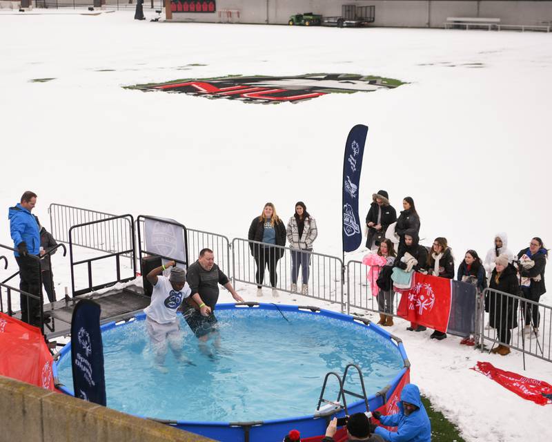 Participants jump into the pool on Saturday, Feb. 15, 2025, during the 2nd annual Polar Plunge at Northern Illinois University's Huskie Stadium in DeKalb. Proceeds benefited the law enforcement torch run for Special Olympics.