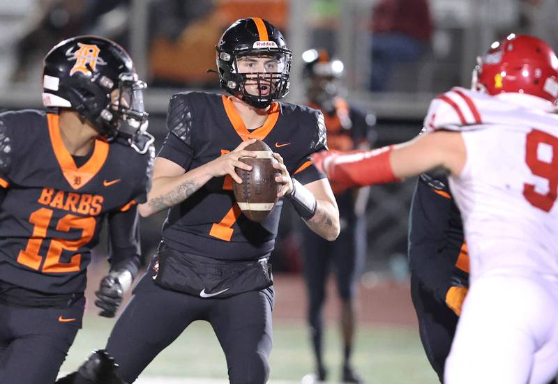 DeKalb's Adrien McVicar looks to pass as Naperville Central's Maverick Ohle applies the pressure during their game Friday Oct. 7, 2022, at DeKalb High School.