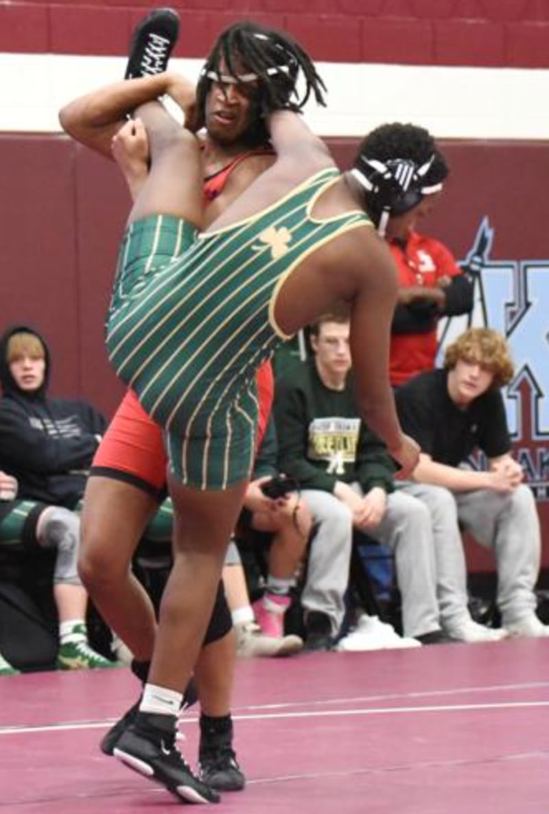 Bradley-Bourbonnais' Quin Flowers, left, attempts a single leg takedown on Bishop McNamara's Will Muthami during Wednesday's All-City meet at Kankakee.