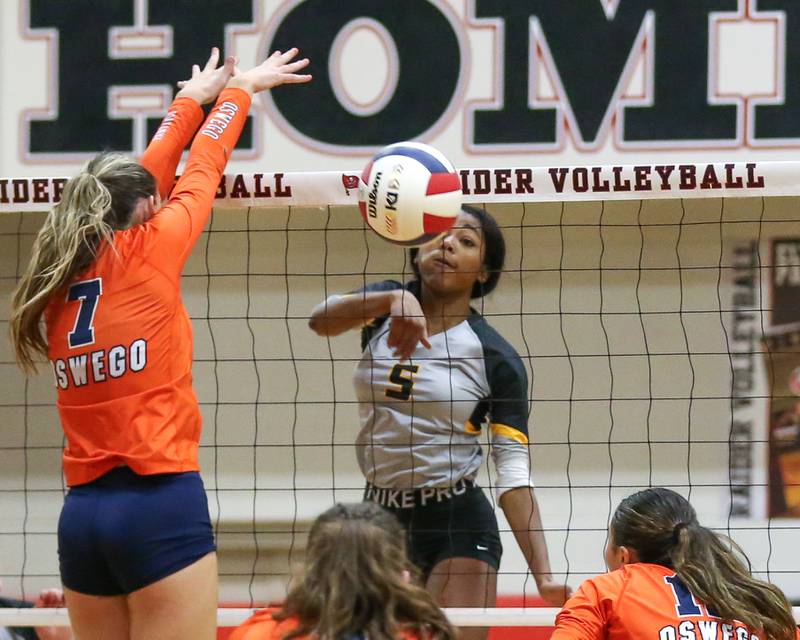 Joliet West's Mady Gant (5) spikes the ball during Class 4A Bolingbrook Sectional semifinal match between Joliet West at Oswego.  Nov 5, 2024  in Bolingbrook.