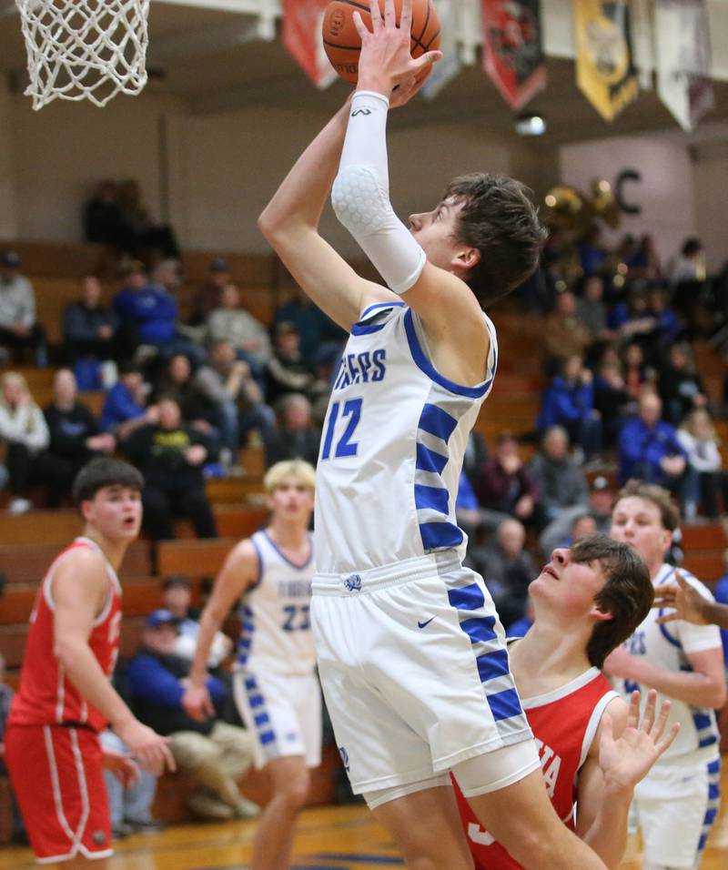 Princeton's Tyson Phillips runs past Ottawa's Drake Kaufman to score on a layup on Monday, Feb. 5, 2024 at Prouty Gym.