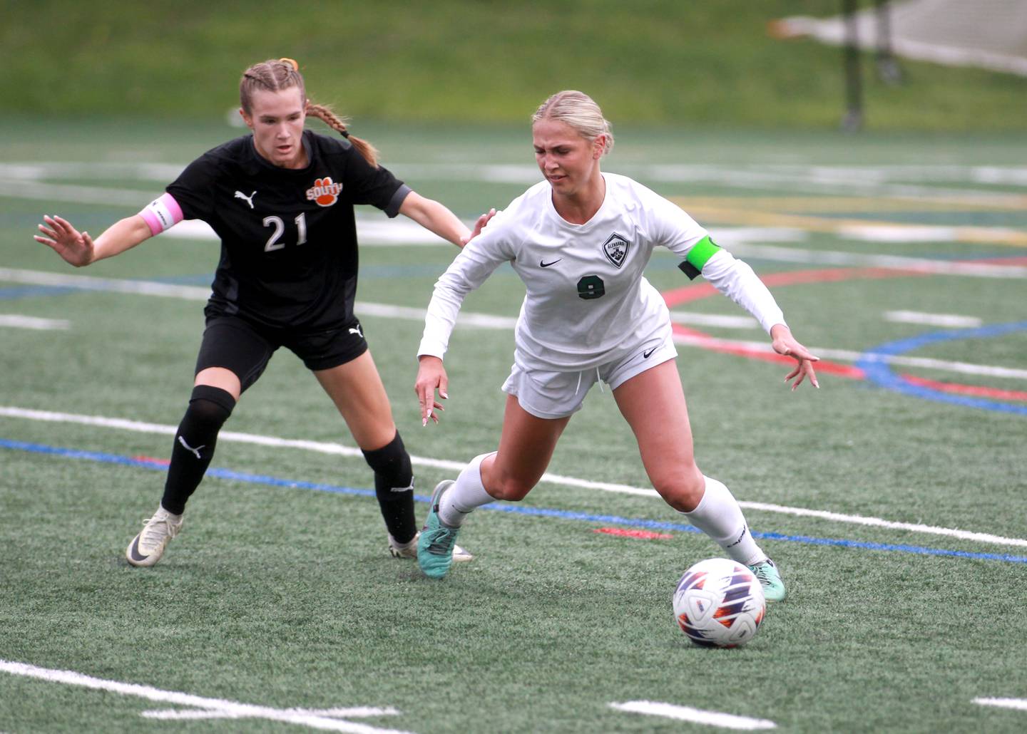 Glenbard West's Hana Allen gets the ball away from Wheaton Warrenville South's Ashlyn Adams during a Class 3A Glenbard West Sectional semifinal game on Tuesday, May 27, 2025 in Glen Ellyn.