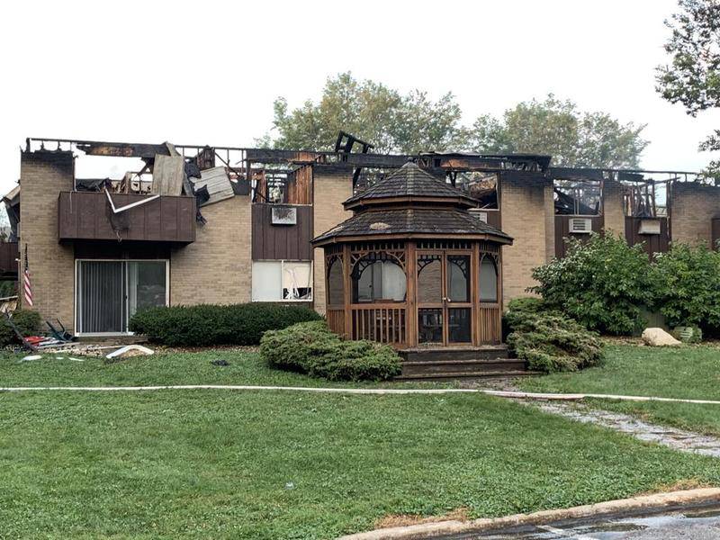 The ruined building in the St. Albans Green apartment complex as seen around 6 a.m. Sunday. A fire official said not everyone in the building when the fire started had been officially located.