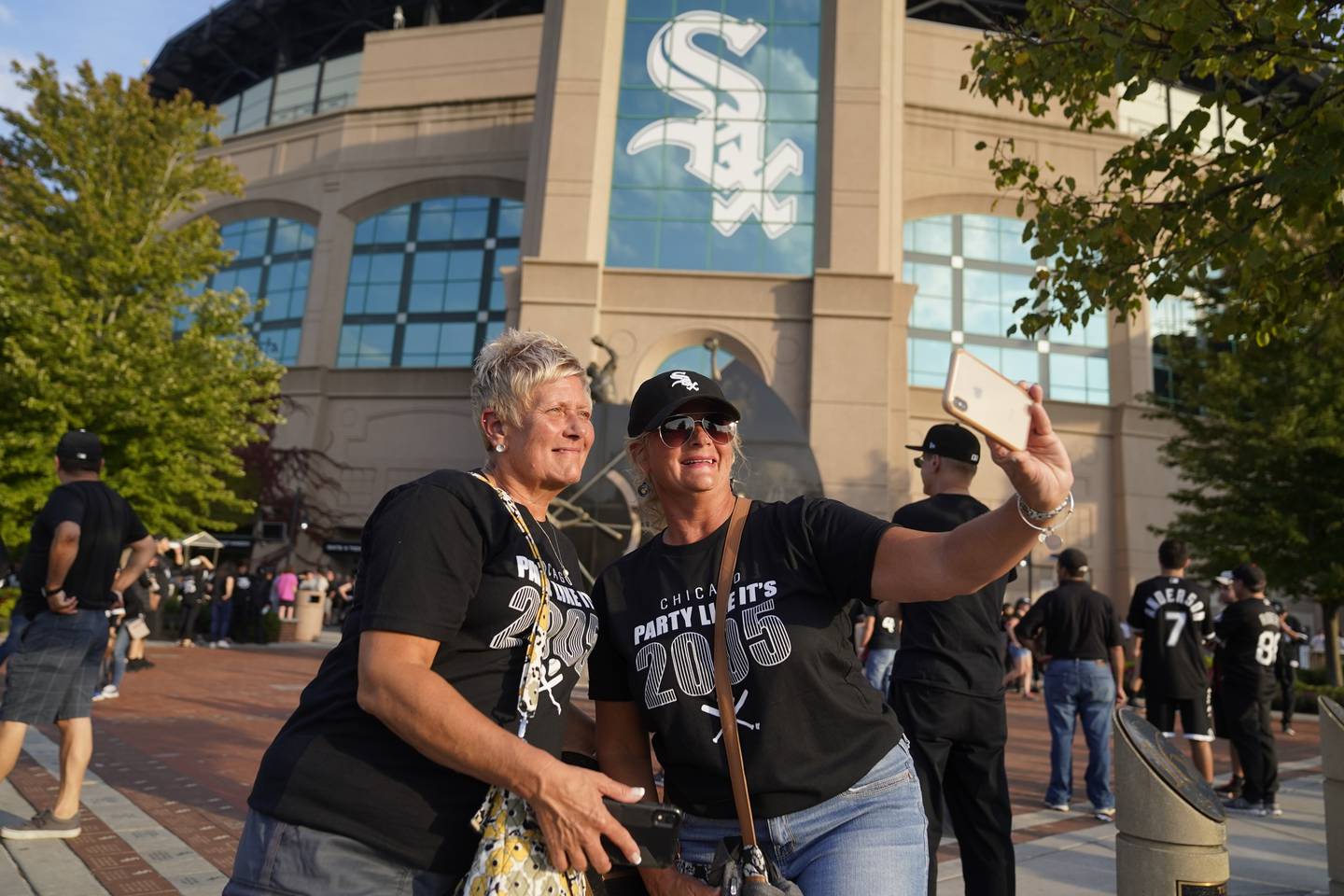 Chicago White Sox fans Debbie Peisker, left, and Cindy Stockle pose for a photo before Game 3 of a baseball American League Division Series against the Houston Astros, Sunday, Oct. 10, 2021, in Chicago. (AP Photo/Charles Rex Arbogast)