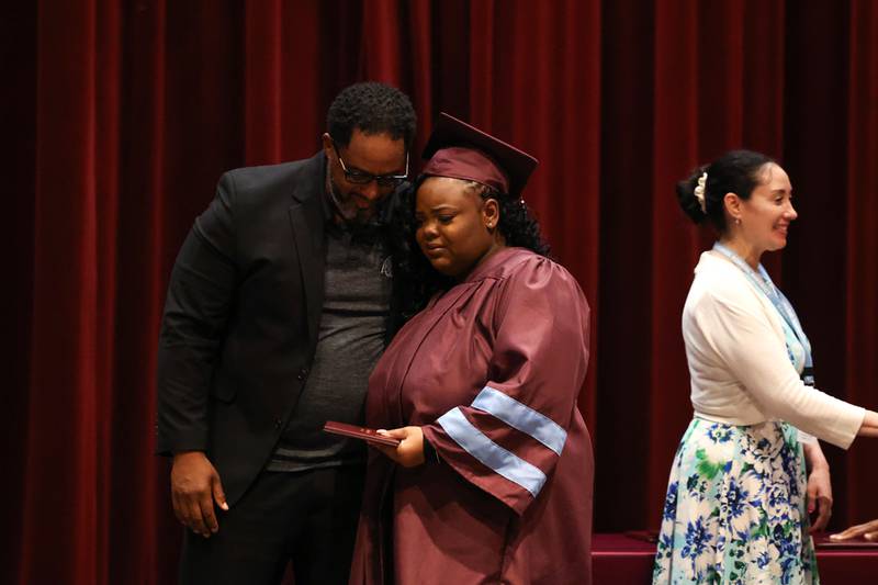 Kankakee High School graduate Lanae Sutton shares an emotional hug with Principal Albert Brass, left, as she receives her diploma during the summer commencement ceremony at the high school on Tuesday, July 29, 2025.