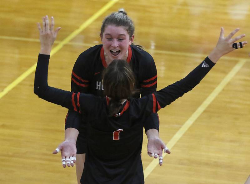 Huntley’s Ally Panzolff, left, spikes the ball as Crystal Lake Central’s Siena Smiejek, center, and Anna Starr, right, during a Fox Valley Conference volleyball match Tuesday, Aug. 23, 2022, between Crystal Lake Central and Huntley at Crystal Lake Central High School.