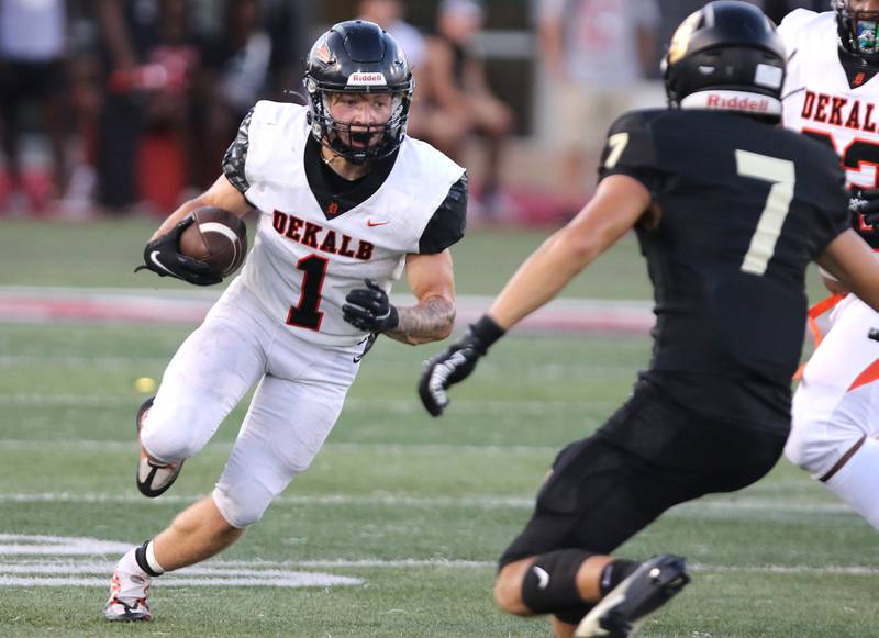 DeKalb's Talen Tate looks to get by Sycamore's Matthew Rangel during the First National Challenge game Friday, Aug. 25, 2023, in Huskie Stadium at Northern Illinois University in DeKalb.