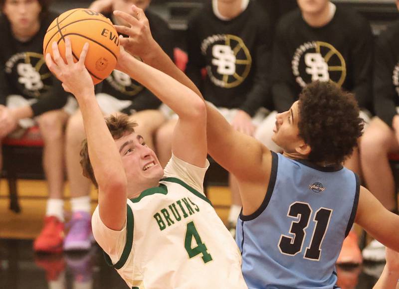 St. Bede's Gino Ferrari eyes the hoop as Bureau Valley's Dakarai Martin misses the block during the Colmone Classic on Thursday, Dec. 11, 2025 at Hall High School.