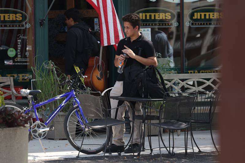 A cyclist takes a water break outside Jitters on Thursday, Sept. 12, 2024 in downtown Joliet.