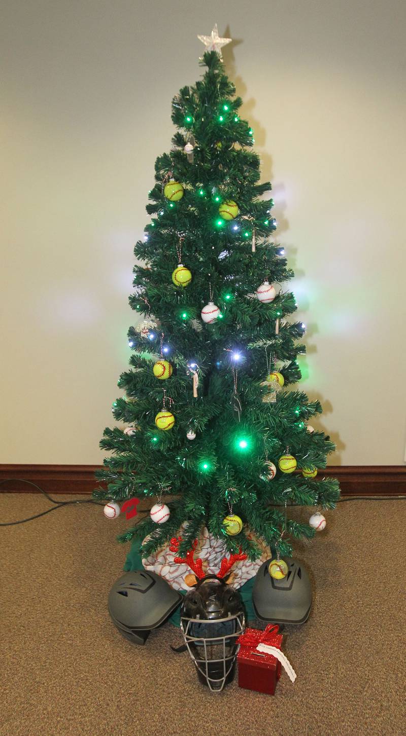 The Avon Township Youth Baseball & Softball tree is decorated and on display in the Giving Trees exhibit at the Grayslake Heritage Center & Museum. Handmade softball, baseball and uniform ornaments hang on the tree.