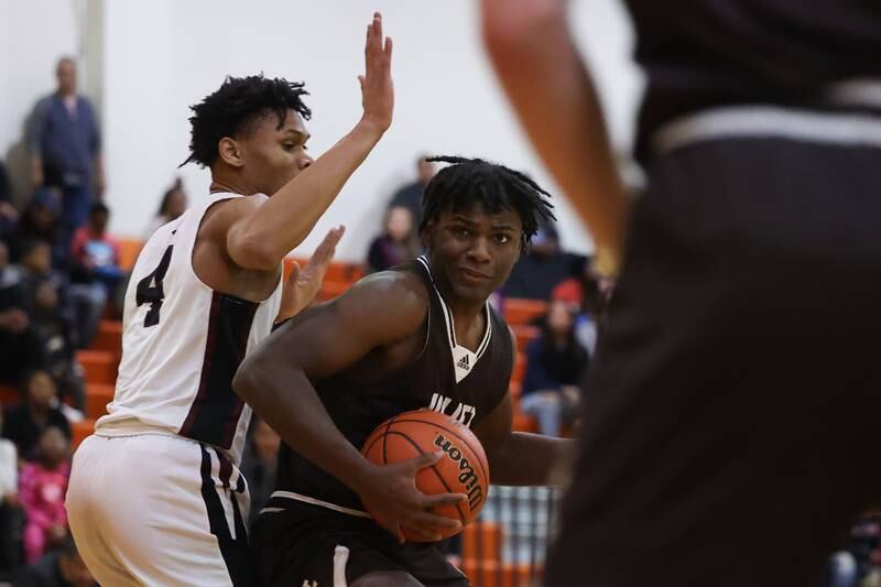 Joliet Catholic’s Christian Holman works around JK Woods of Prespectives in the Class 2A Julian Sectional championship on Friday, March 3rd, 2023 in Chicago.