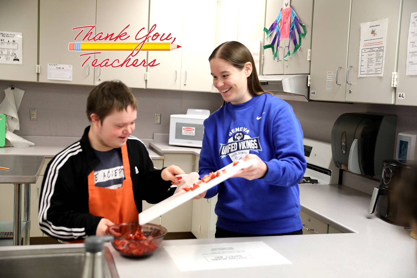 Cailla Swanson, a learning behavior specialist at Geneva High School, works with student Ian Thomson during a cooking class.