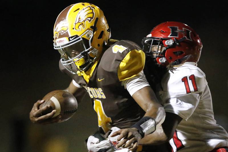 Jacobs' Nasir Canty, left, runs the ball as he is hit by Huntley's Dashaun Manning during their football game at Jacobs High School on Frdiay, Sept. 24, 2021 in Algonquin.