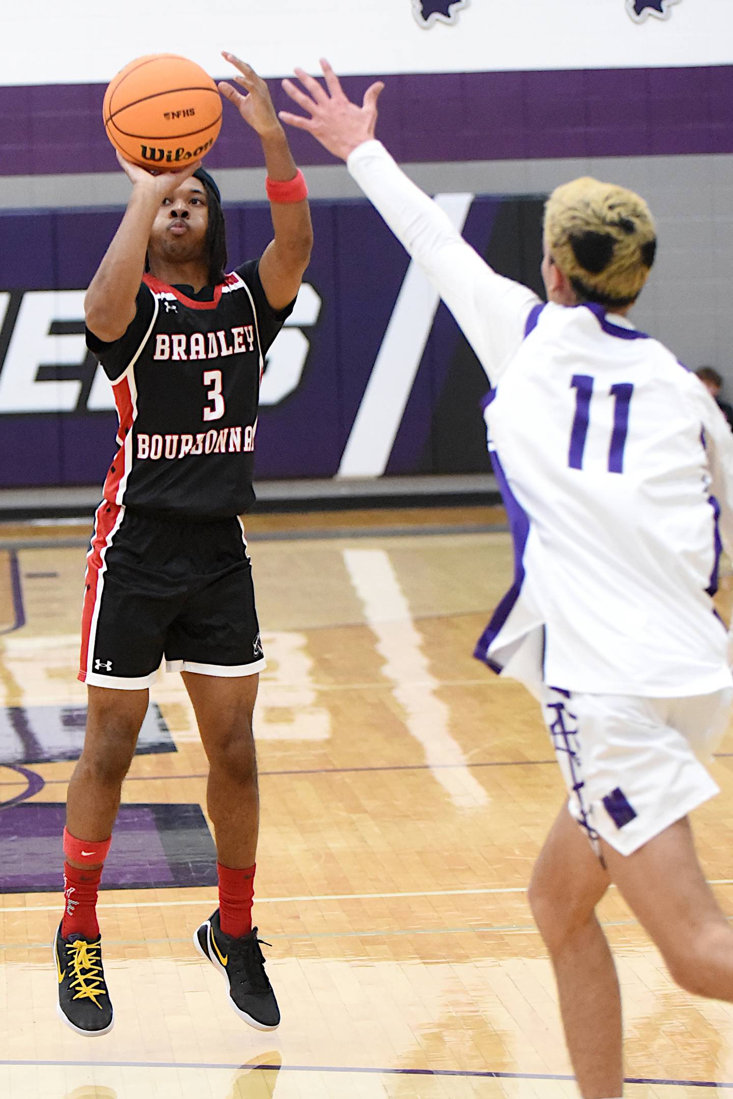 Bradley-Bourbonnais' Tez Smith, left, shoots a 3-pointer as Manteno's Braden Campbell defends during a game at Manteno Saturday, Dec. 6, 2025.