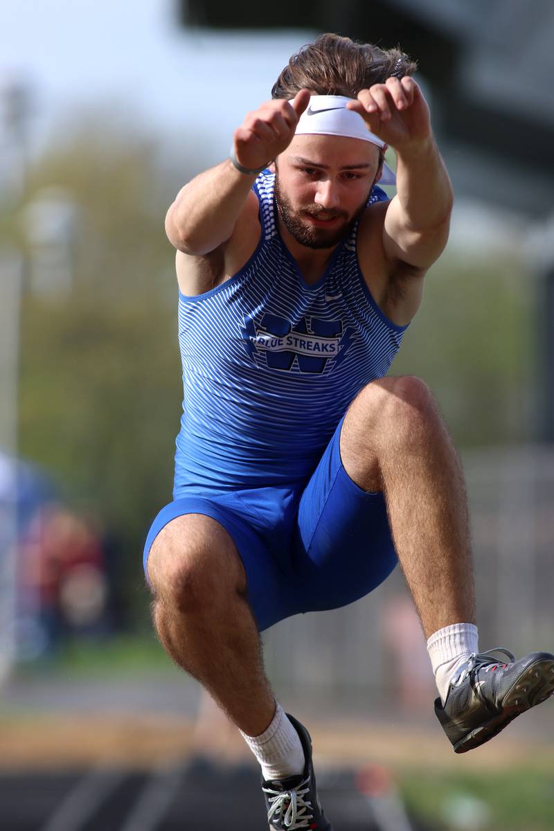 Woodstock’s Jared Kniola competes in the triple jump during Kishwaukee River Conference track meet action at Marengo Tuesday night.