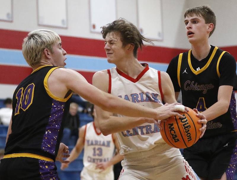 Chicago Christian's Malachi Krestel knocks the ball away from Marian Central's Derek Leitzen as he drive to the basket during a Chicagoland Christian Conference basketball game on Tuesday, Jan. 21, 2025, at Marian Central High School.
