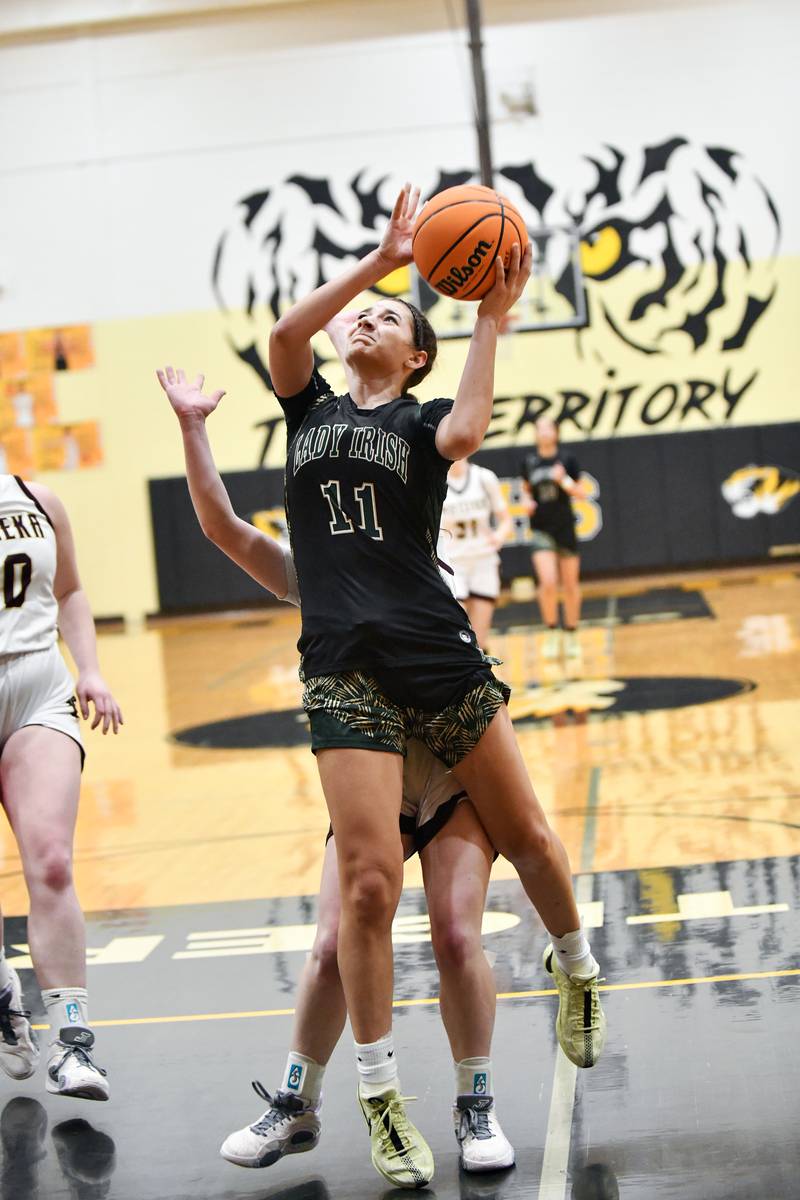 Bishop McNamara's Trinity Davis goes for a layup during the Fightin' Irish's 69-38 victory over Watseka-Milford in the IHSA Class 2A Herscher Sectional championship on Thursday, Feb. 27.