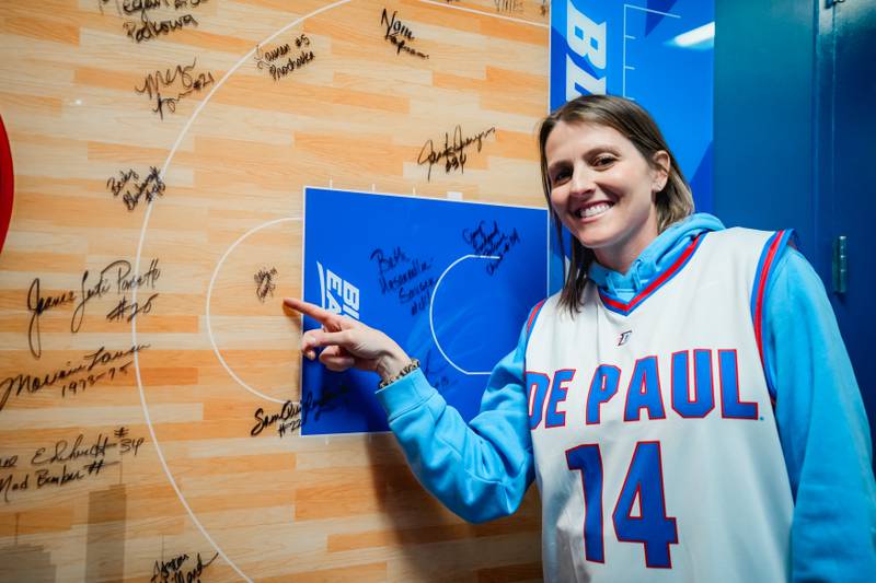Allie Quigley points to her signature on the wall of the DePaul women's locker room.